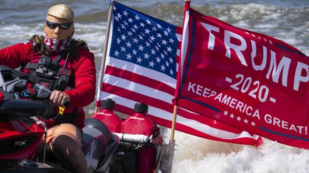 A person dressed as President Donald Trump drives a jet ski during the "Nation's Capital Trumptilla Boat Parade" on the Potomac River (AFP) A person dressed as President Donald Trump drives a jet ski during the "Nation's Capital Trumptilla Boat Parade" on the Potomac River (AFP)