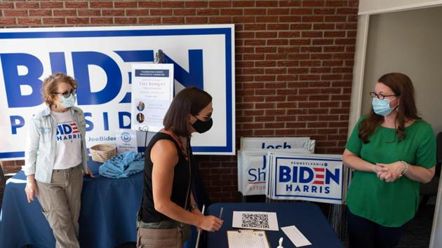 A woman signs up for a mailing list in the Washington county Democratic office before taking a yard sign for Presidential candidate Joe Biden in Washington, Pennsylvania (AFP) A woman signs up for a mailing list in the Washington county Democratic office before taking a yard sign for Presidential candidate Joe Biden in Washington, Pennsylvania (AFP)