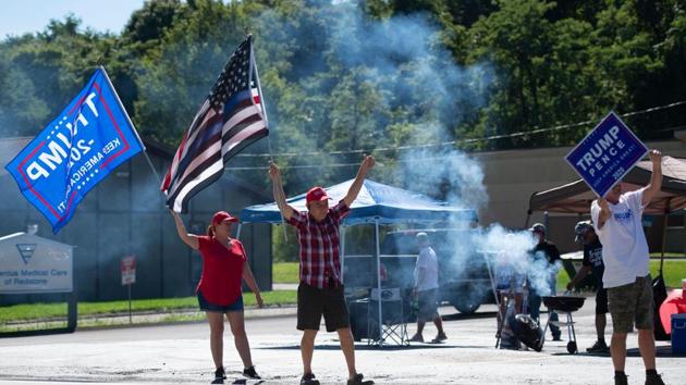 Supporters of US President Donald Trump hold up signs and flags as they hold a Republican voter registration in Brownsville, Pennsylvania (AFP) Supporters of US President Donald Trump hold up signs and flags as they hold a Republican voter registration in Brownsville, Pennsylvania (AFP)