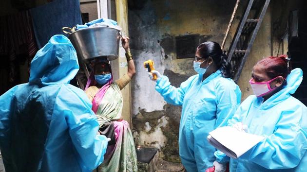 Healthcare workers conduct thermal screening of a resident for Covid-19, at Dharavi, in Mumbai. (ANI) Healthcare workers conduct thermal screening of a resident for Covid-19, at Dharavi, in Mumbai. (ANI)