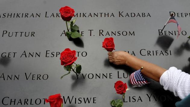 In this file photo, a woman places flowers in the inscribed names along the edge of the North Pool during memorial observances on the anniversary of the Sept. 11, 2001 terror attacks on the World Trade Center in New York.(AP photo)