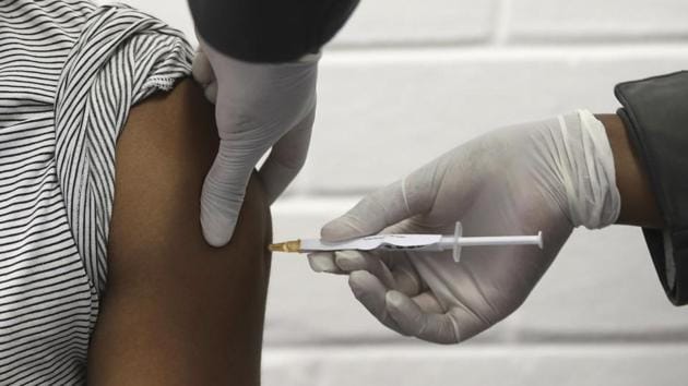A volunteer receives an injection at the Chris Hani Baragwanath hospital in Soweto, Johannesburg. This is part of Africa's first participation in a COVID-19 vaccine trial developed at the University of Oxford in Britain in conjunction with the pharmaceutical company AstraZeneca. (Siphiwe Sibeko/Pool via AP)