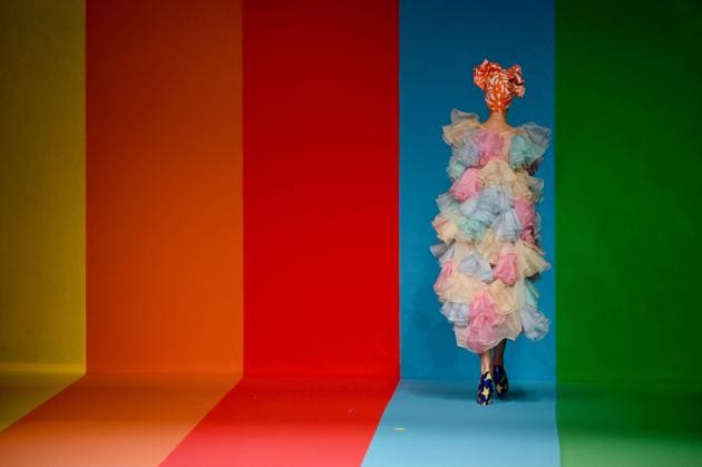 A model walks against the rainbow striped background as she presents a creation from Spanish designer Agatha Ruiz de la Prada's Spring/Summer 2021 collection during the Mercedes Benz Fashion Week in Madrid on September 10, 2020.  (AFP) 