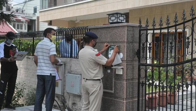 Authorities pasting home-quarantine notice outside a house in Chandigarh on Friday. (Ravi Kumar/HT) Authorities pasting home-quarantine notice outside a house in Chandigarh on Friday. (Ravi Kumar/HT)