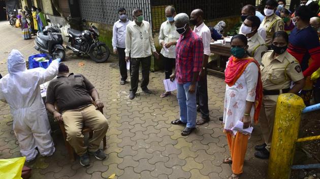 BMC medical staff conducts swab test on police personnel and their families.(Anshuman Poyrekar/HT Photo)