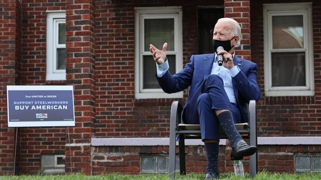 Wearing a face mask to reduce the risk posed by the coronavirus, Democratic presidential nominee Joe Biden talks with members of the United Steelworkers union in a supporter's back yard (AFP) Wearing a face mask to reduce the risk posed by the coronavirus, Democratic presidential nominee Joe Biden talks with members of the United Steelworkers union in a supporter's back yard (AFP)