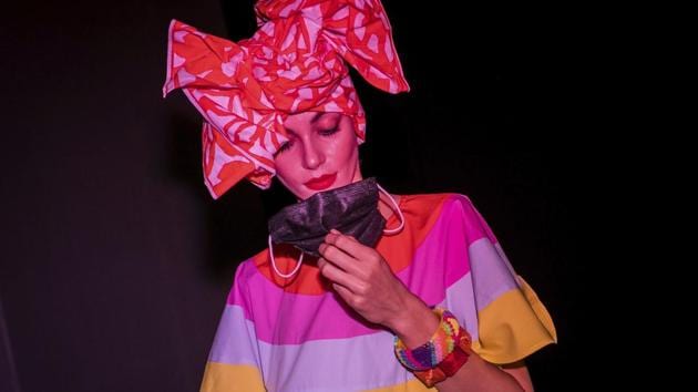 A model holds a face mask prior the fashion show of Spanish designer Agatha Ruiz de la Prada during the Mercedes-Benz Fashion Week in Madrid, Spain, Thursday, Sept. 10, 2020. The Spanish fashion week takes place from 10 to 13 September under new security measures and social distance guidelines due the coronavirus pandemic. (AP) A model holds a face mask prior the fashion show of Spanish designer Agatha Ruiz de la Prada during the Mercedes-Benz Fashion Week in Madrid, Spain, Thursday, Sept. 10, 2020. The Spanish fashion week takes place from 10 to 13 September under new security measures and social distance guidelines due the coronavirus pandemic. (AP)