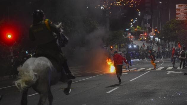 Demonstrators run as police on horses chase them during a protest against police brutality in Medellin, Colombia on September 10. At least 10 people were killed and hundreds wounded after rioting broke out in the Colombian capital Bogota during protests over the death of a man repeatedly tasered by police. (Joaquin Sarmiento / AFP) Demonstrators run as police on horses chase them during a protest against police brutality in Medellin, Colombia on September 10. At least 10 people were killed and hundreds wounded after rioting broke out in the Colombian capital Bogota during protests over the death of a man repeatedly tasered by police. (Joaquin Sarmiento / AFP)