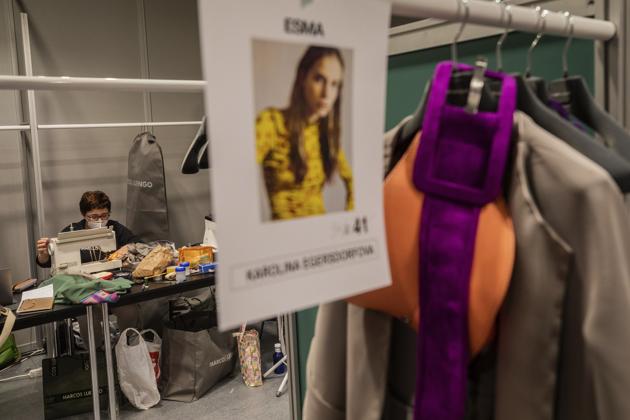 A staffer of Spanish designer Marcos Luengo works at the backstage a day before the start of the Mercedes-Benz Fashion Week in Madrid, Spain, Wednesday, Sept. 9, 2020.  (AP) 