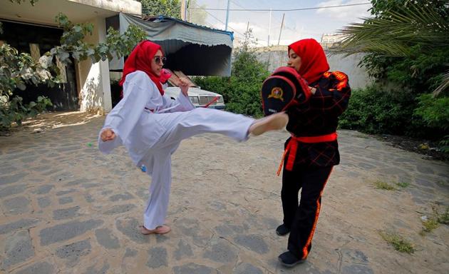 Martial arts trainer Seham Amer practices self-defense moves with a trainee at a house in Sanaa, Yemen September 5, 2020.(REUTERS)