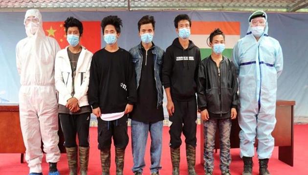 The five young men accompanied by army personnel from India and China (at extreme right and left) at Kibithu on Saturday.(INDIAN ARMY.) The five young men accompanied by army personnel from India and China (at extreme right and left) at Kibithu on Saturday.(INDIAN ARMY.)