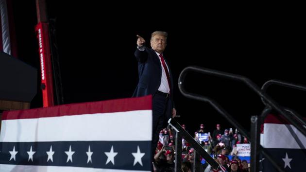 President Donald Trump points to the crowd after speaking during a campaign rally at MBS International Airport, in Freeland.(AP)