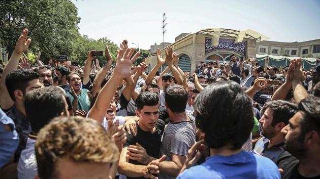 In this June 25, 2018 file photo, a group of protesters chant slogans at the main gate of the Old Grand Bazaar, in Tehran, Iran. On Saturday, Sept. 5, 2020, Iran broadcast the televised confession of a wrestler facing the death penalty after a tweet from President Donald Trump criticizing the case.(AP)