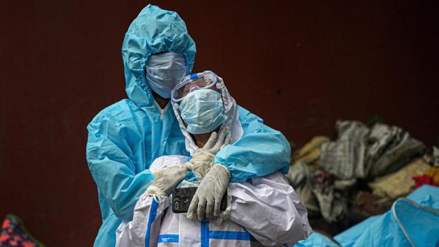 A woman (foreground) is consoled at a cremation site in Guwahati, Assam, on September 10, after she lost her husband to COVID 19. An estimated 6.4 million people were infected with the coronavirus disease (Covid -19) in India by early May, findings of the first national sero survey conducted by the Indian Council of Medical Research show. (Anupam Nath / AP) A woman (foreground) is consoled at a cremation site in Guwahati, Assam, on September 10, after she lost her husband to COVID 19. An estimated 6.4 million people were infected with the coronavirus disease (Covid -19) in India by early May, findings of the first national sero survey conducted by the Indian Council of Medical Research show. (Anupam Nath / AP)