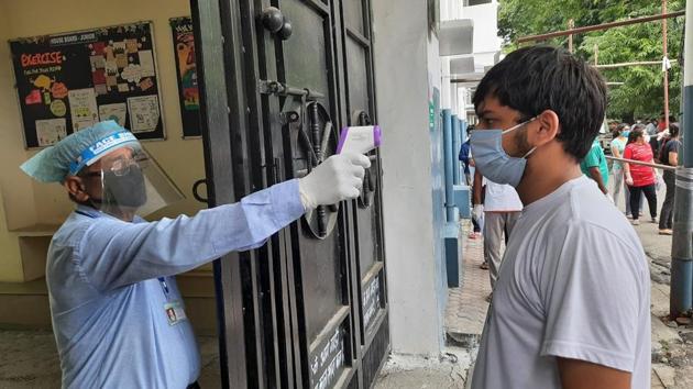 Students being checked before being allowed to enter a NEET examination centre in Nainital district on Sunday. (HT Photo) Students being checked before being allowed to enter a NEET examination centre in Nainital district on Sunday. (HT Photo)