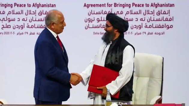 Mullah Abdul Ghani Baradar, the leader of the Taliban delegation, and Zalmay Khalilzad, US envoy for peace in Afghanistan, shake hands after signing an agreement at a ceremony between members of Afghanistan’s Taliban and the US in Doha, Qatar.(Reuters)