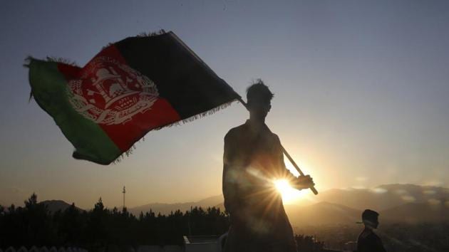 A man waves an Afghan flag during Independence Day celebrations in Kabul, Afghanistan.(AP)