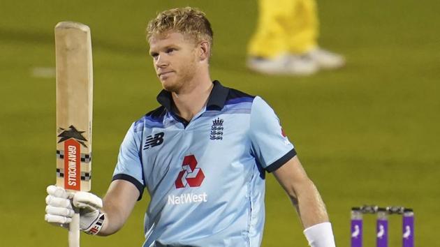 England's Sam Billings raises his bat to celebrate scoring a century during the first ODI cricket match between England and Australia, at Old Trafford in Manchester, England.(AP)