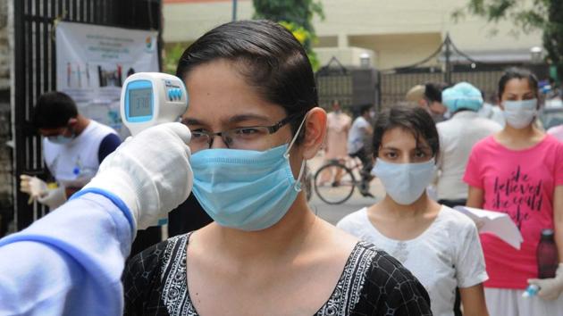 Students being thermally scanned at a centre for the National Eligibility cum Entrance Test in Chandigarh on Sunday. (Keshav Singh/H) Students being thermally scanned at a centre for the National Eligibility cum Entrance Test in Chandigarh on Sunday. (Keshav Singh/H)