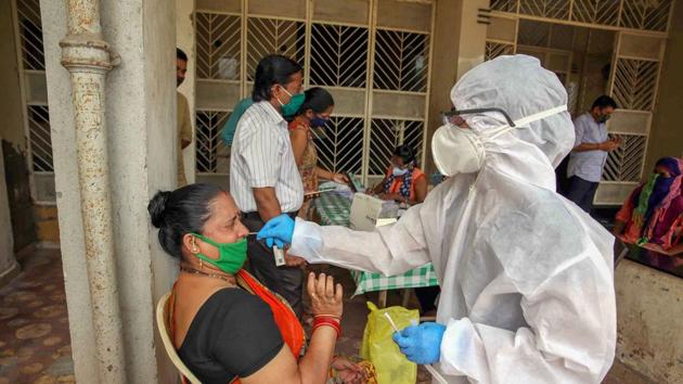 A health worker collects swab sample during Covid-19 Rapid Antigen test in Mumbai on September 8. (PTI) A health worker collects swab sample during Covid-19 Rapid Antigen test in Mumbai on September 8. (PTI)