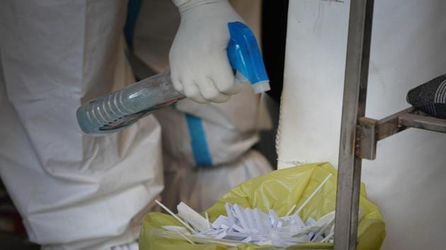 A health worker chemically disinfects testing kits used for detecting Covid-19 infection at Shadipur in New Delhi on September 13. While measures are being taken by both the Centre and state governments to cut the disease transmission, the total number of new cases being reported each day is inching closer to 100,000. (Sanchit Khanna / HT Photo)