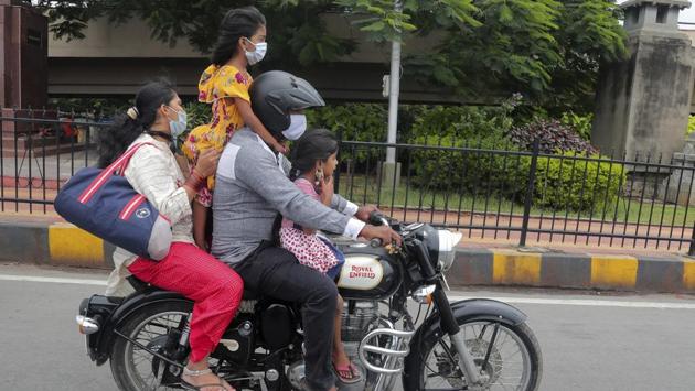 A family wearing face masks on a motorbike in Hyderabad on September 13. Maharashtra (28.79%), Karnataka (10.05%), Andhra Pradesh (9.84%), Uttar Pradesh (6.98%) and Tamil Nadu (4.84%) account for 60% of the active Covid-19 cases in the country, HT reported. (Mahesh Kumar A. / AP) A family wearing face masks on a motorbike in Hyderabad on September 13. Maharashtra (28.79%), Karnataka (10.05%), Andhra Pradesh (9.84%), Uttar Pradesh (6.98%) and Tamil Nadu (4.84%) account for 60% of the active Covid-19 cases in the country, HT reported. (Mahesh Kumar A. / AP)