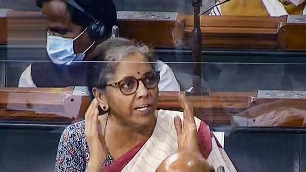 Union Finance Minister Nirmala Sitharaman speaks from behind a protective screen during the monsoon session of Parliament in New Delhi on September 14. Following preventive measures against the virus, glass-like plastic shields of varied sizes were installed in front of benches to protect members from coronavirus. (PTI)