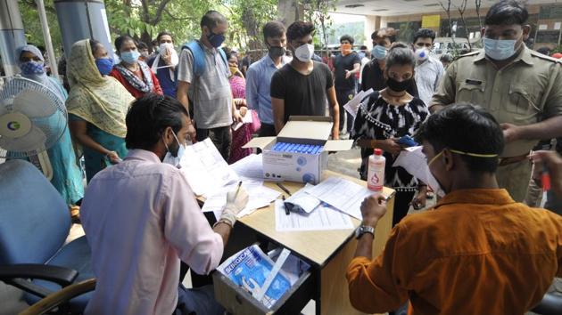People queue outside a Covid-19 test registration desk at District Hospital, in Sector 30, Noida on September 14. On September 15, 83,809 new cases were reported in India, taking the total number of Covid-19 positive cases in the country to close to 5 million (49,30,236). (Sunil Ghosh / HT Photo)