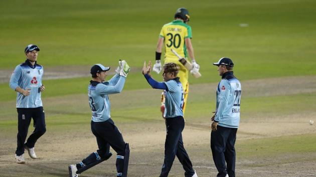 Cricket - Second One Day International - England v Australia - Emirates Old Trafford, Manchester - September 13, 2020 England's Tom Curran celebrates the wicket of Australia's Pat Cummins with teammates Pool via REUTERS/Martin Rickett (Pool via REUTERS) Cricket - Second One Day International - England v Australia - Emirates Old Trafford, Manchester - September 13, 2020 England's Tom Curran celebrates the wicket of Australia's Pat Cummins with teammates Pool via REUTERS/Martin Rickett (Pool via REUTERS)