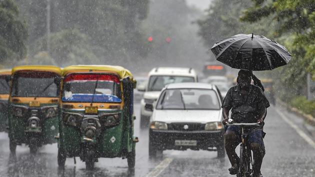 Vehicles move through heavy rain in New Delhi earlier in September. (PTI) Vehicles move through heavy rain in New Delhi earlier in September. (PTI)