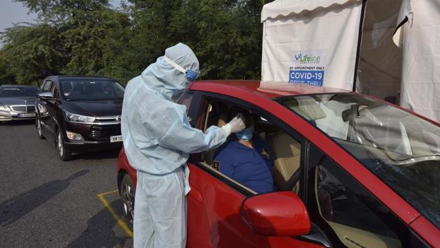 A health worker takes a sample for Covid-19 test at a drive through testing facility in New Delhi on September 12. The health minister also shared in his address that India is conducting about one million tests per day which translates to 720 tests per million population per day, much higher than that stipulated by World Health Organization which is 140 tests per million per day. (Sanjeev Verma / HT Photo) A health worker takes a sample for Covid-19 test at a drive through testing facility in New Delhi on September 12. The health minister also shared in his address that India is conducting about one million tests per day which translates to 720 tests per million population per day, much higher than that stipulated by World Health Organization which is 140 tests per million per day. (Sanjeev Verma / HT Photo)
