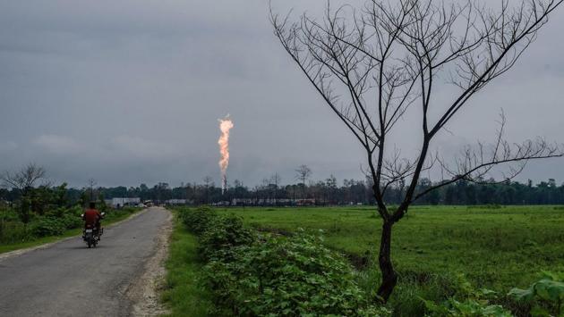 A motorist rides on a road leading towards the Oil India Limited (OIL)’s gas well blowout site in Baghjan on September 11. The Assam Pollution Control Board had issued a closure notice to the Baghjan Oil field in June on the grounds that OIL had been operating without obtaining prior consent to establish and operate from the Assam Pollution Control Board, PTI reported. (Manish Sharma / PTI)