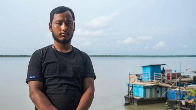 Prakash Saikia, a resident of Baghjan, poses for a portrait in the backdrop of the Dibru Saikhowa National Park near OIL’s gas well blowout site in Baghjan on September 11. “Even after compensation what will I do anywhere else. Here I have two ponds and other business to sustain my family. Anywhere else, I am unemployed,” Saikia told PTI. (Manish Sharma / PTI)