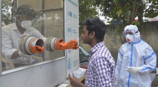 A health worker collects swab sample for coronavirus test in Ghaziabad on Tuesday.(Sakib Ali/HT Photo) A health worker collects swab sample for coronavirus test in Ghaziabad on Tuesday.(Sakib Ali/HT Photo)