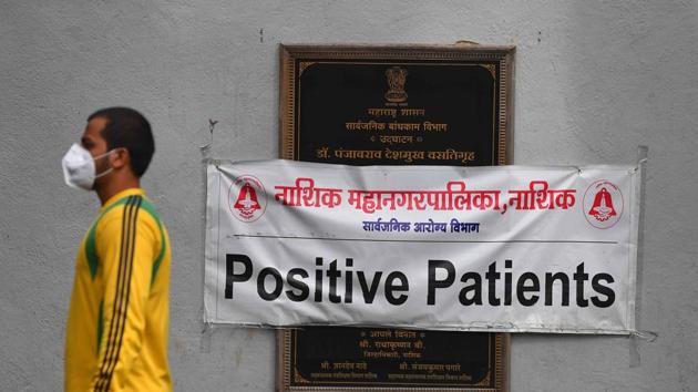 A man walks past a sign reading ‘Positive Patients’ at a quarantine centre in Nashik on September 13. The number of coronavirus infected people in the country crossed 5 million after 90,123 many tested positive for the disease within 24 hours on September 16. (Indranil Mukherjee / AFP)