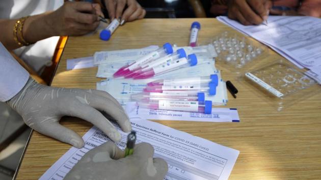 A health worker registers people for coronavirus testing at a district hospital in Noida on September 11. Keeping up with the widespread testing and treatment of the infected, the government is now refocusing to facilitate the development of a vaccine. “More than 30 candidates have been supported which are in different stages of development,” Vardhan announced while sharing centre’s strategy in the parliament’s monsoon session on September 15. (Sunil Ghosh / HT Photo) A health worker registers people for coronavirus testing at a district hospital in Noida on September 11. Keeping up with the widespread testing and treatment of the infected, the government is now refocusing to facilitate the development of a vaccine. “More than 30 candidates have been supported which are in different stages of development,” Vardhan announced while sharing centre’s strategy in the parliament’s monsoon session on September 15. (Sunil Ghosh / HT Photo)