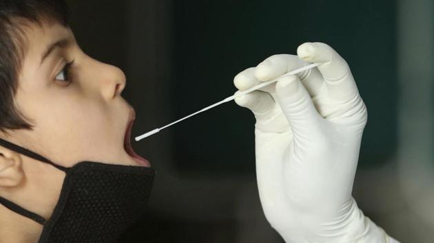 A health worker collects a swab sample to test for COVID-19 at a government hospital in Jammu, India, Tuesday, Sept. 15, 2020. India's coronavirus cases are now the second-highest in the world and only behind the United States.(AP)