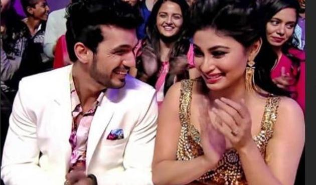 Arjun Bijlani with Mouni Roy at an event.