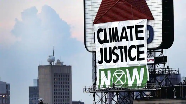 File photo: Banner reads ’Climate Justice Now’ on the iconic Citgo sign near Fenway Park in Kenmore Square, Boston, US.(AP) File photo: Banner reads ’Climate Justice Now’ on the iconic Citgo sign near Fenway Park in Kenmore Square, Boston, US.(AP)