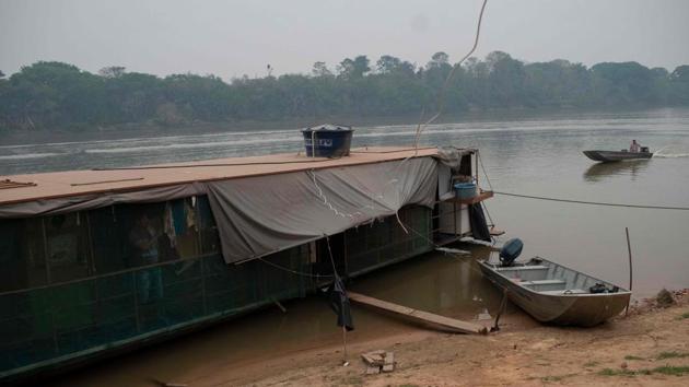 A man is seen inside his boat house in the Porto do Jofre community in the Pantanal, near the Transpantaneira park road which crosses the world's largest tropical wetland, in Mato Grosso State, Brazil, on September 13. “The fires are causing great damage to fauna, flora and to the Pantanal region,” Salles told Reuters. (Mauro Pimentel / AFP)