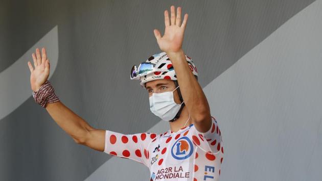 France's Benoit Cosnefroy wearing the best climbers polka dot jersey waves to the media upon his arrival for the start of Stage 17 from Grenoble to Meribel Col de la Loze in France on September 16. At the end of the round, Colombia’s Miguel Angel Lopez registered a win and to climb third in the overall standings. Stage 18 of the race will commence from Meribel on September 17. (Christophe Ena,Pool / AP)