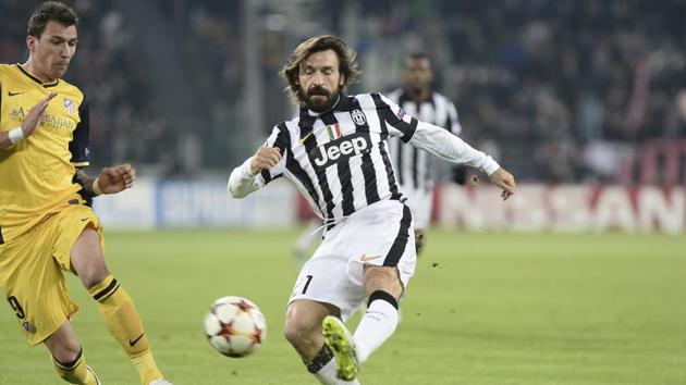 FILE - In this Dec. 9, 2014 file photo, Juventus' Andrea Pirlo, right, challenges the ball with Atletico' Mario Mandzukic during a Champions League, Group A, soccer match between Juventus and Atletico de Madrid at the Juventus stadium in Turin, Italy. New Juventus coach Andrea Pirlo had his coaching qualification rubber-stamped by the Italian soccer federation on Wednesday, Sept. 16, 2020.(AP)