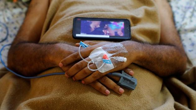 A patient suffering from the coronavirus disease (COVID-19), listens a song on a mobile phone at the Intensive Care Unit (ICU) of the Yatharth Hospital in Noida, on the outskirts of New Delhi, India, September 15, 2020. Picture taken September 15, 2020. (Representational image)(REUTERS)