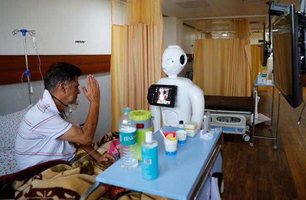 A patient suffering from the coronavirus disease (COVID-19) speaks to his family members, using a robot named 'Mitra' at the Intensive Care Unit (ICU) of the Yatharth Super Speciality Hospital in Noida, on the outskirts of New Delhi, India, September 15, 2020. (REUTERS)