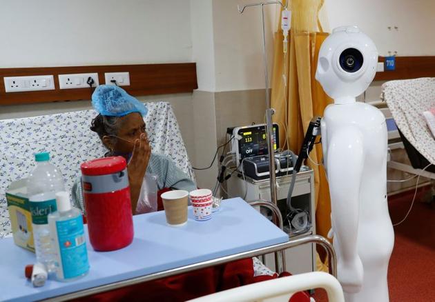 A patient suffering from the coronavirus disease (COVID-19) speaks to her family members, using 'Mitra' at the Intensive Care Unit (ICU) of the Yatharth Super Speciality Hospital in Noida, on the outskirts of New Delhi, India, September 15, 2020. (REUTERS)