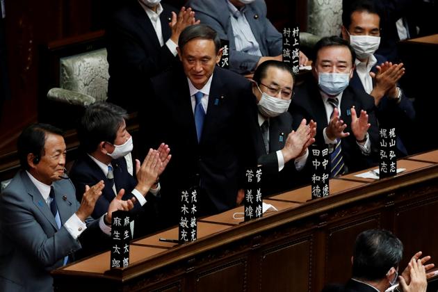 Japan's newly-elected Prime Minister Yoshihide Suga stands as he was chosen as new prime minister at the Lower House of Parliament in Tokyo, Japan (REUTERS/Kim Kyung-Hoon)