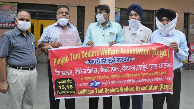 Members of tent dealers association protesting outside the DC office in Ludhiana, on Wednesday. (Gurpreet Singh/HT) Members of tent dealers association protesting outside the DC office in Ludhiana, on Wednesday. (Gurpreet Singh/HT)