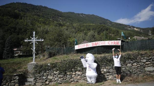 Fans cheer for their team during the Tour de France race between Grenoble to Meribel Col De La Loze in France on September 16. The race is immensely popular and telecasted in nearly 190 countries in addition to thousands of those who flock to cheer their favourites from the sidelines. This year the authorities have put restrictions on the fans’ attendance as a precautionary measure amid coronavirus spread. (Stephane Mahe / REUTERS)
