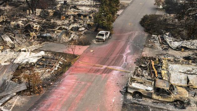 The remains of homes and vehicles line a residential street at Talent in Oregon on September 16. Fire Almeda which is said to have started in Ashland, south of Talent on the morning of September 8, spread 13 miles (20 kilometers) north after blowing for nearly a week. (Nathan Howard / AFP)