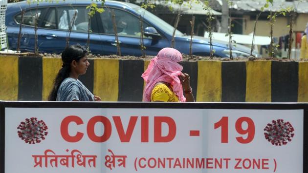 Commuters walk past a Covid-19 containment zone billboard at Wagholi in Pune on September 15. According to the health ministry data, 27 states and union territories are reporting recovery rates of more than 70 per cent. (Shankar Narayan / HT Photo) Commuters walk past a Covid-19 containment zone billboard at Wagholi in Pune on September 15. According to the health ministry data, 27 states and union territories are reporting recovery rates of more than 70 per cent. (Shankar Narayan / HT Photo)